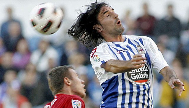 Juan Rodriguez winning a ball during La LIGA match representing deportivo la Coruna