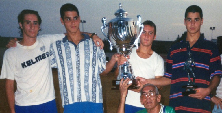 Player from Malaga CF Academy posing after winning a tournament. Christian Marin (Left) with the twins Emilio (Center Left) and Javi Guerra (Right)